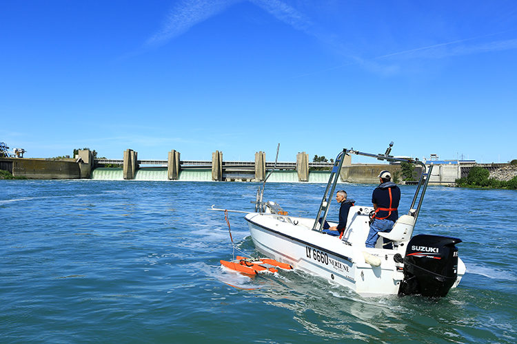 France, Rhone (69), Barrage de retenue de Pierre Benite sur le Rhone, au sud de Lyon, equipe de jaugeage effectuant des traverses pour mesurer le debit du Rhone a l’aval, instrument de mesure a effet Doppler type ‘‘River Ray’’ monte sur flotteur